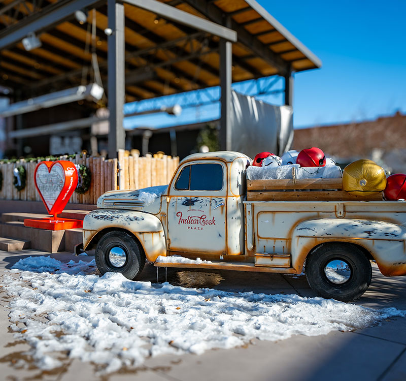 Truck at Indian Creek in Caldwell with snow in the foreground.