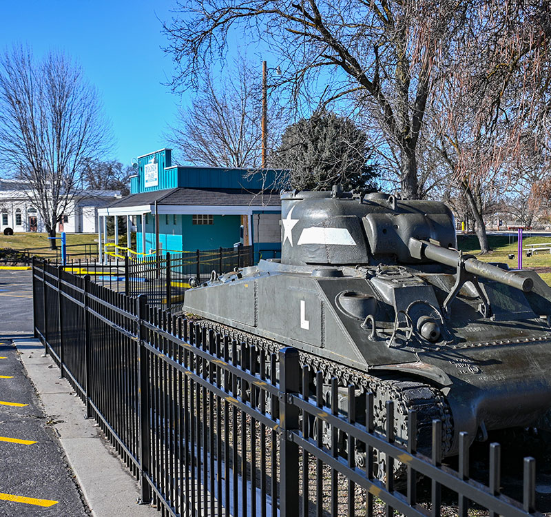 Park in Middleton with a tank and old western building in the background.
