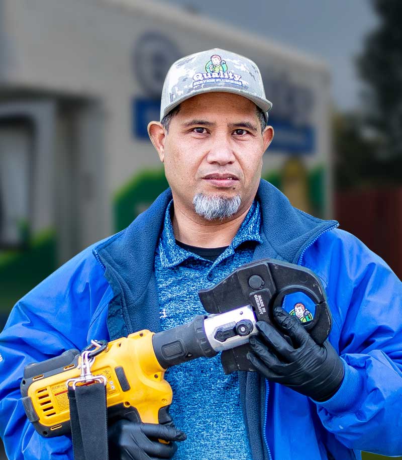 Local Plumber holding plumbing equipement