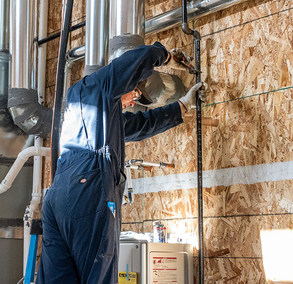 Plumber installing gas line pipe.