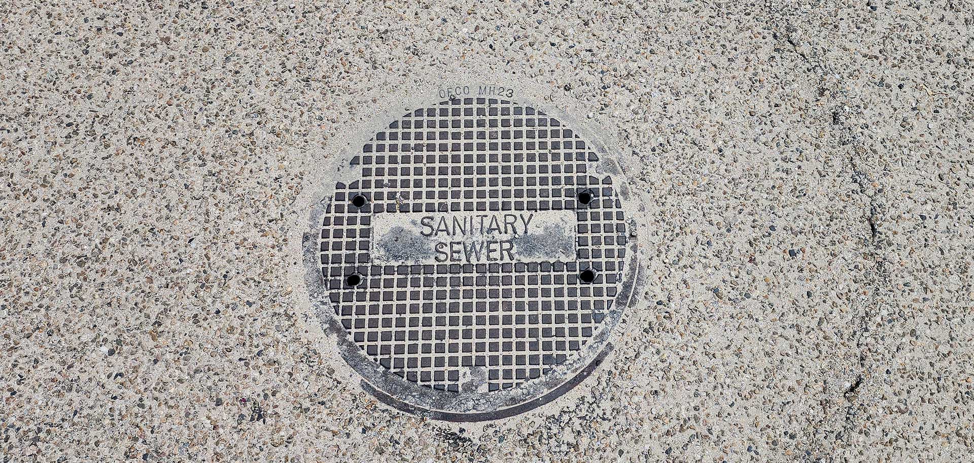 Sanitary Sewer man hole in the street.