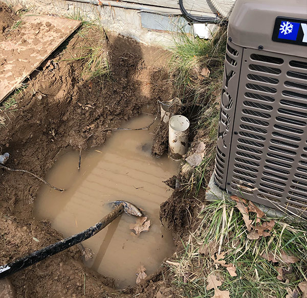 Flooding in a yard next to the air conditioner.