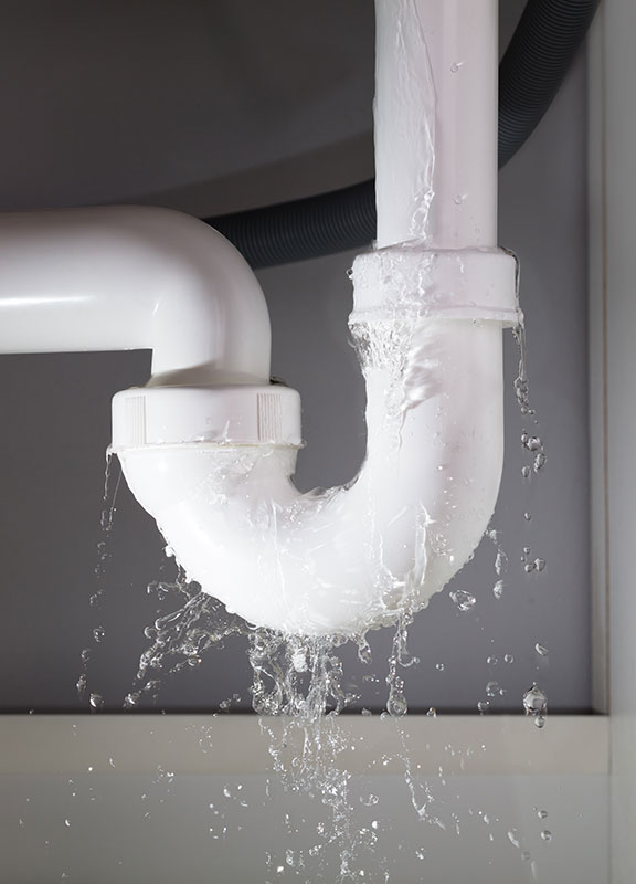Water leaking from pipe under sink