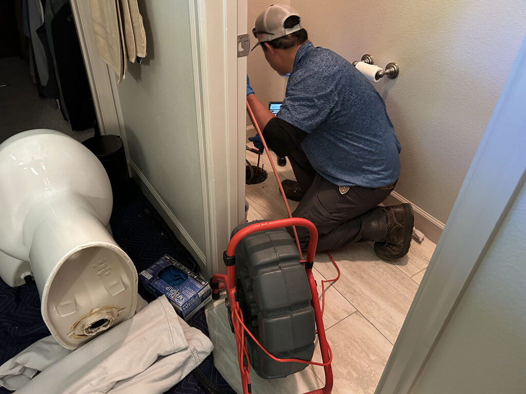 Quality Service Plumbing Team Inspecting a Clogged Drain